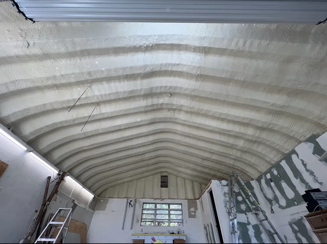 Spray polyurethane foam applied to the underside of a metal roof deck in Seneca Falls